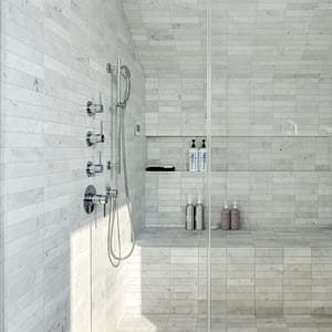 White Carrara subway tile in Loch Arbour sets a soothing atmosphere of luxury and escape.