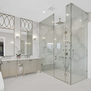 Stunning upscale bathroom in replace with large shower area and matching vanity sinks.