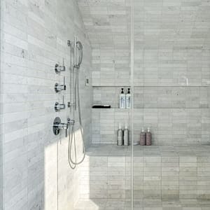 White Carrara subway tile in Millstone sets a soothing atmosphere of luxury and escape.